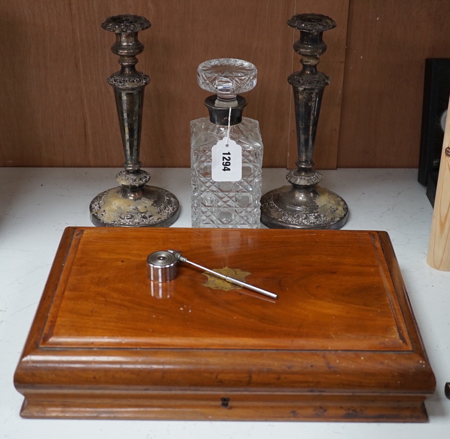 A silver mounted spirit decanter, a pair of plated candlesticks and canteen box, decanter 24 cms high